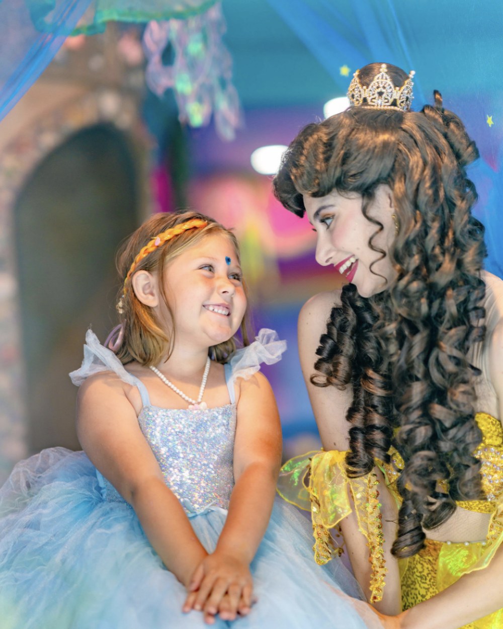 A birthday girl in her gown sharing a moment with her princess host at Once Upon an Island