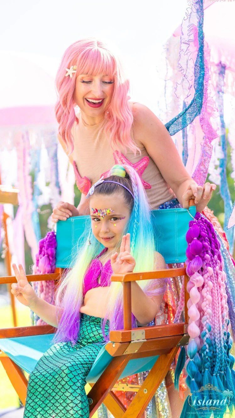 A mermaid makeover with colorful braids and face gems at Mermaid Cove