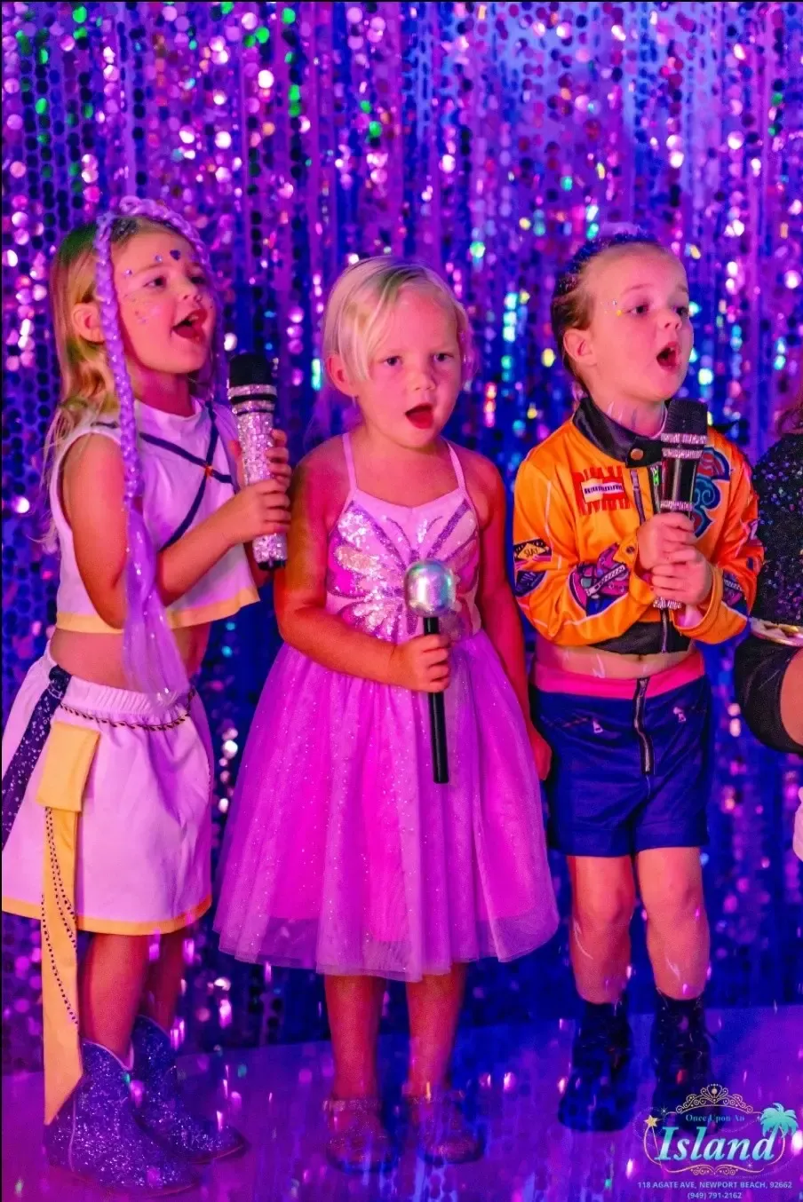 Three little performers singing their hearts out