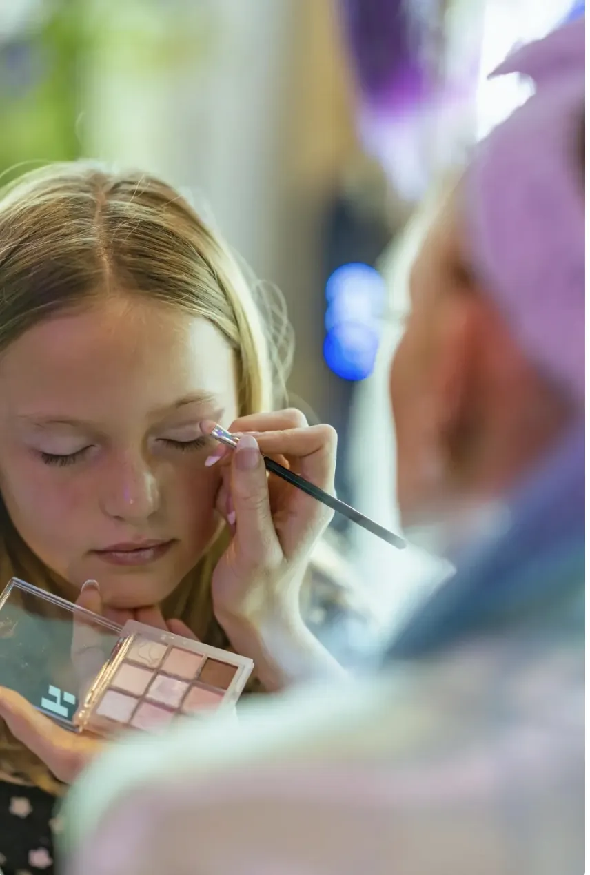 A young guest getting age-appropriate glam makeup