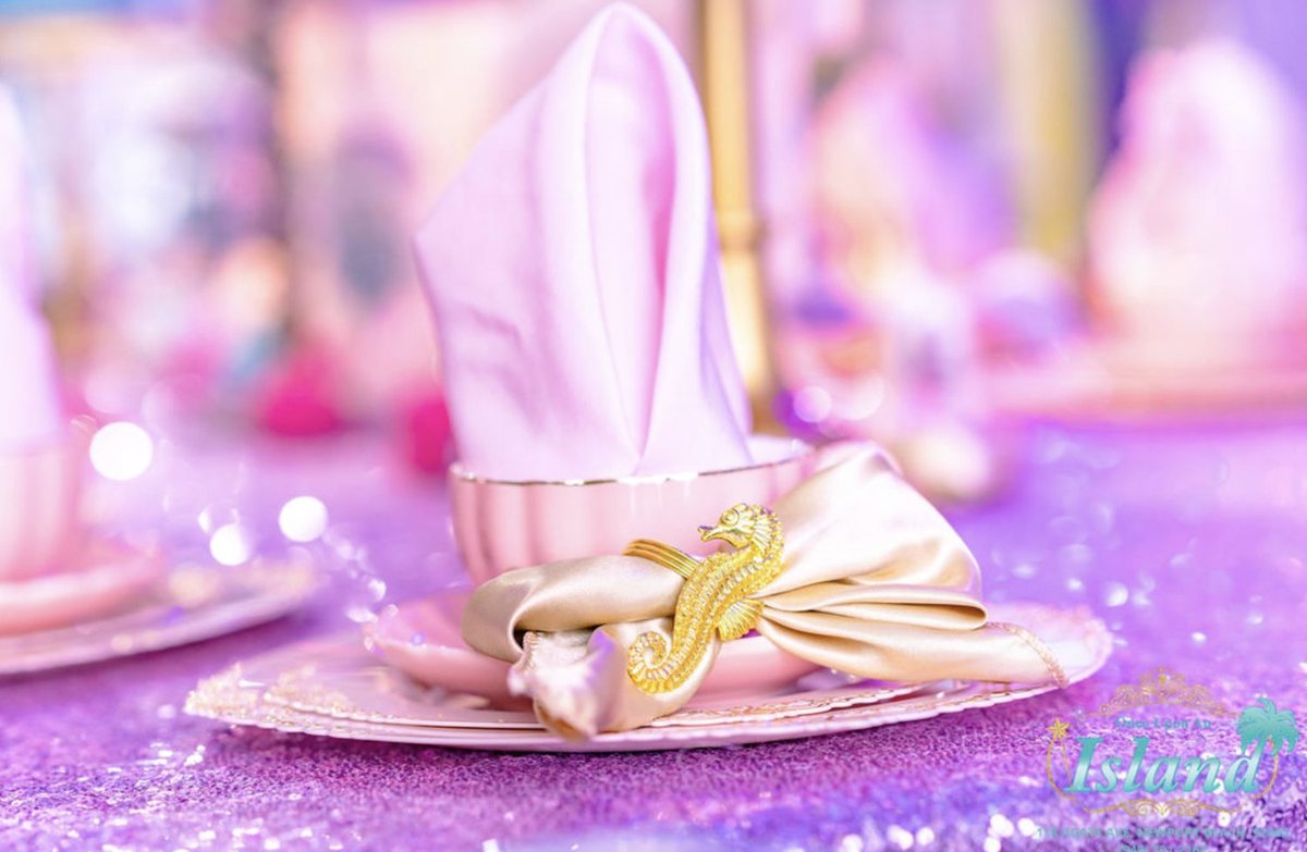 A pink place setting with a ribboned napkin and glitter table at a Princess Tea Party