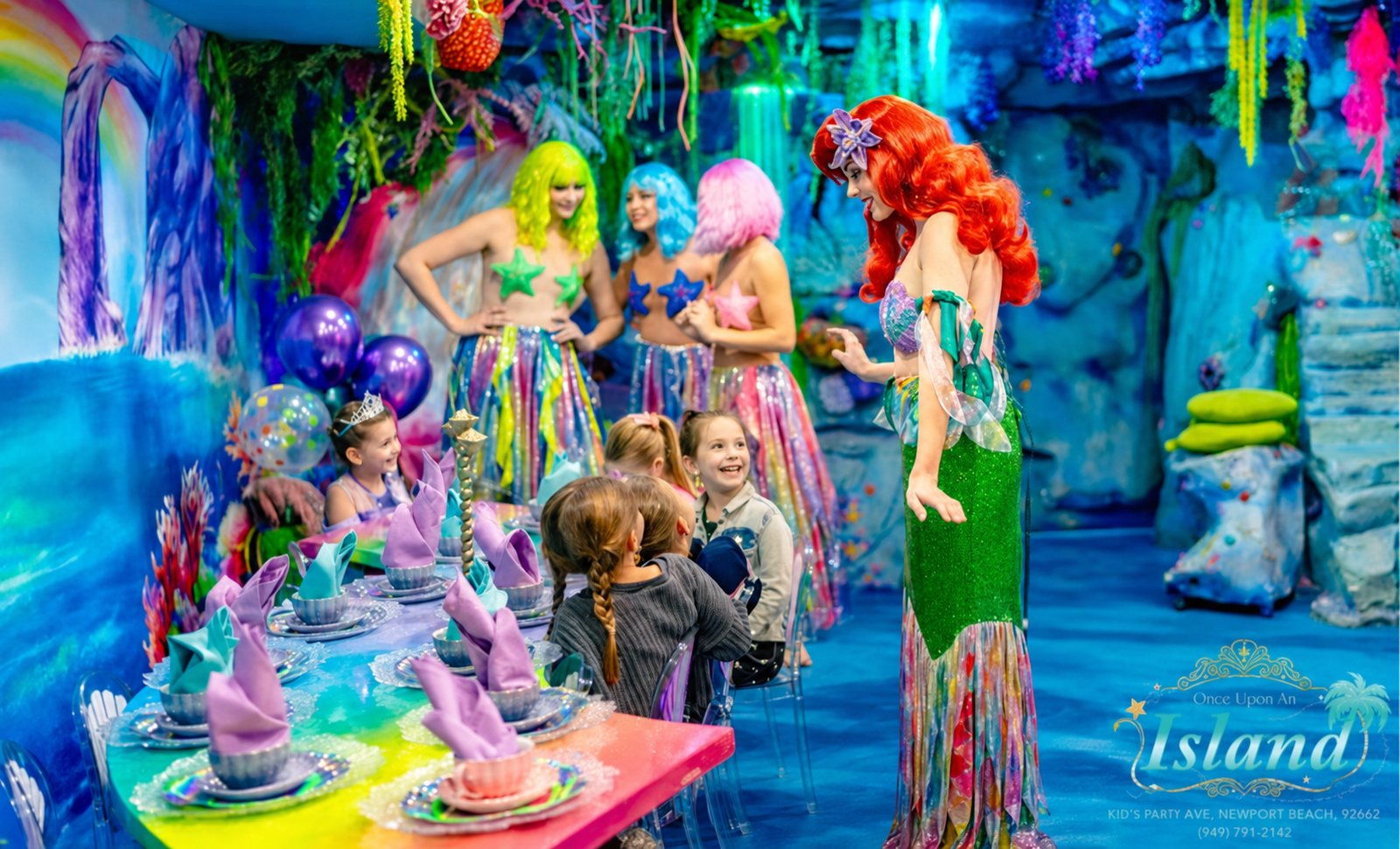 A princess greeting the children at the set tea table with her Neverland Mermaids at a Princess Tea Party
