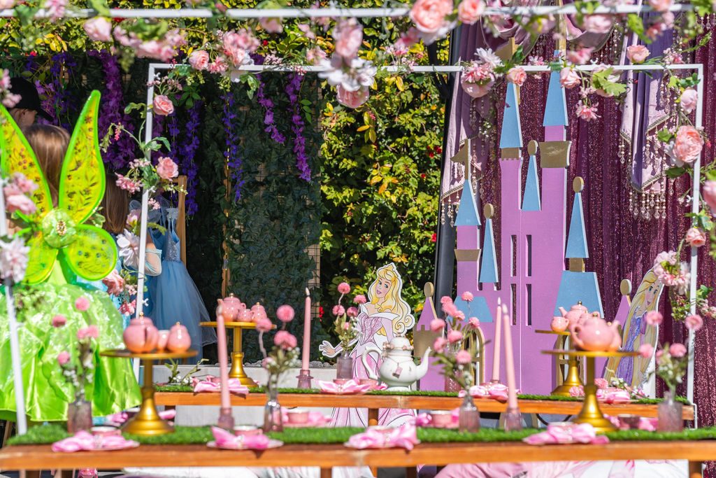 The floral backdrop and finished tea table at a princess travel party