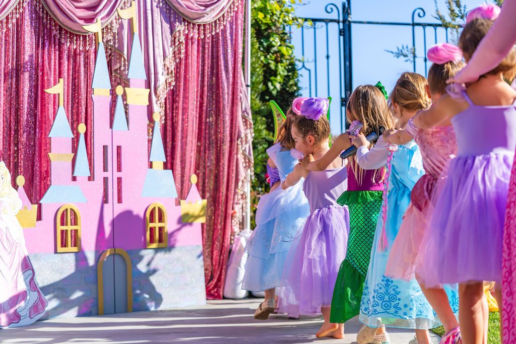 Children in costume lining up at the five-foot castle backdrop brought to a travel party