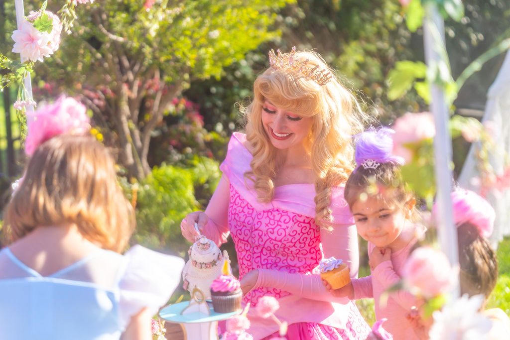 A princess host with children at a Princess Tea Party brought to a home in Orange County