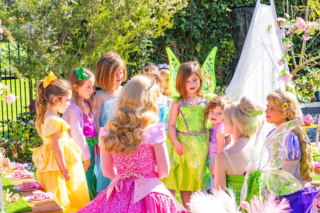 The host character and her cast with the children at a full-service travel party