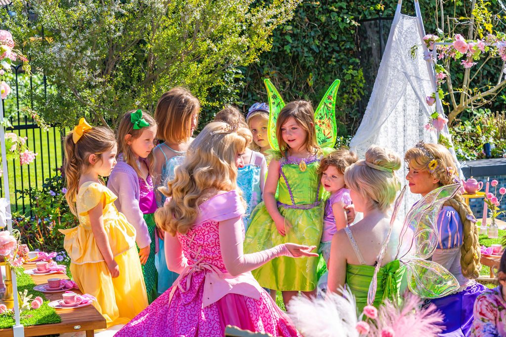 Children in costume gathered with their host character at a full-service travel party