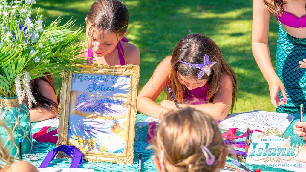 Children decorating their own treasure bags at the craft station