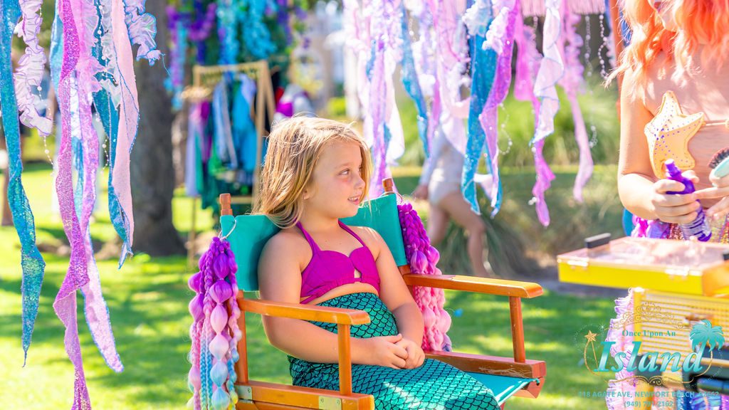 A child waiting in the salon chair at the traveling makeover station