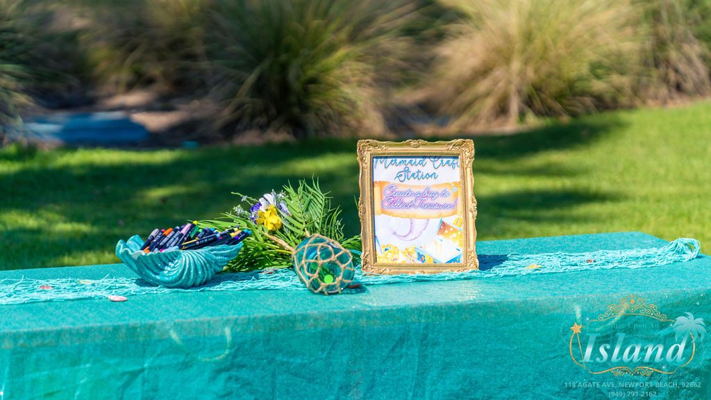 The welcome and gift table set with shells at a mermaid travel party