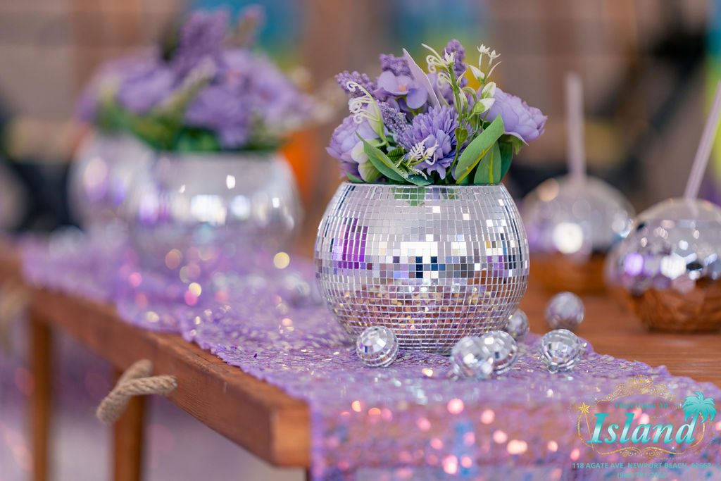 Disco balls and florals down the table at a pop star travel party
