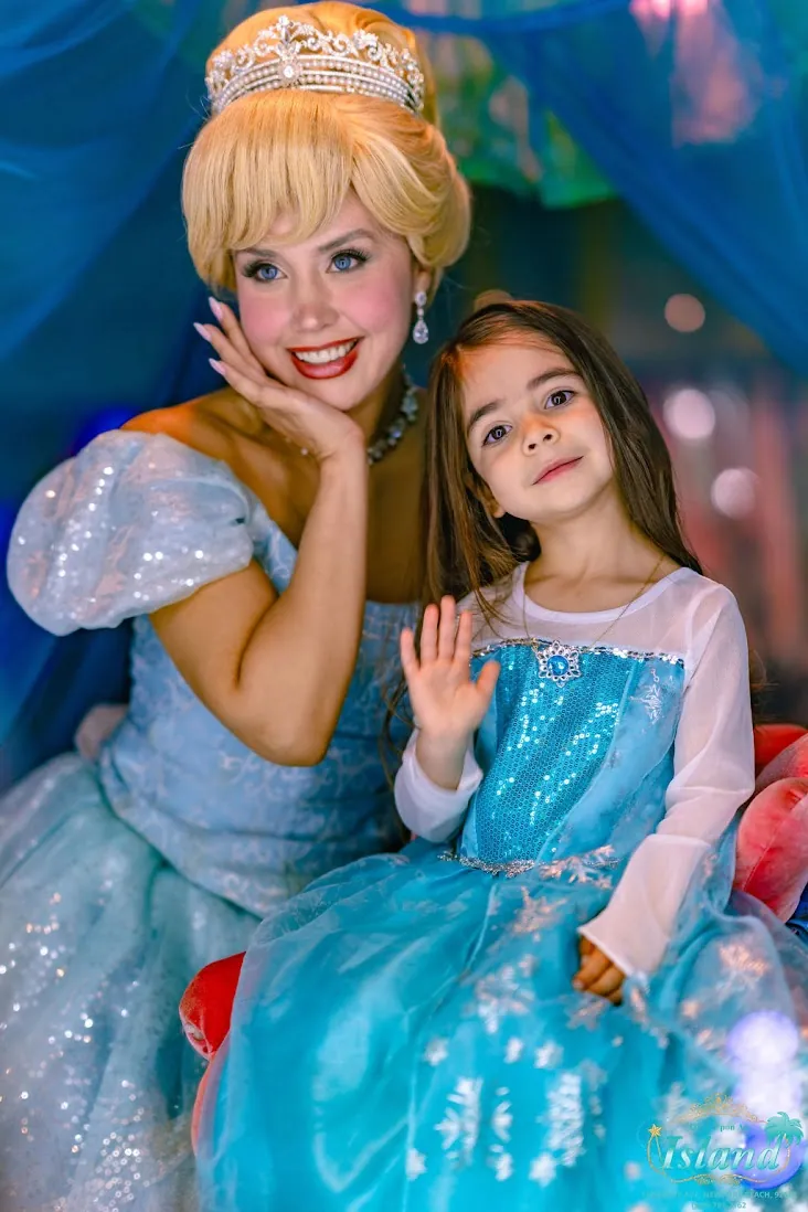 A mother watching her daughter meet her princess hosts