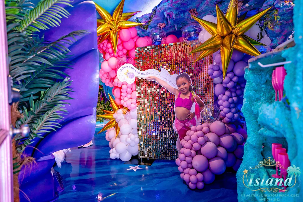 A custom wish-wall photo moment with shimmer backdrop and balloon installation