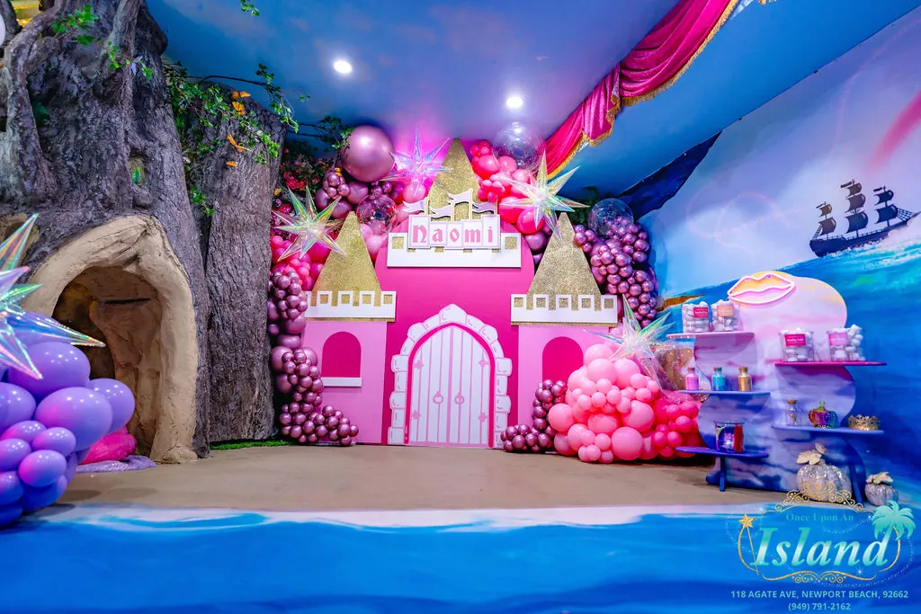 The full custom castle set with balloon installations and treasure styling