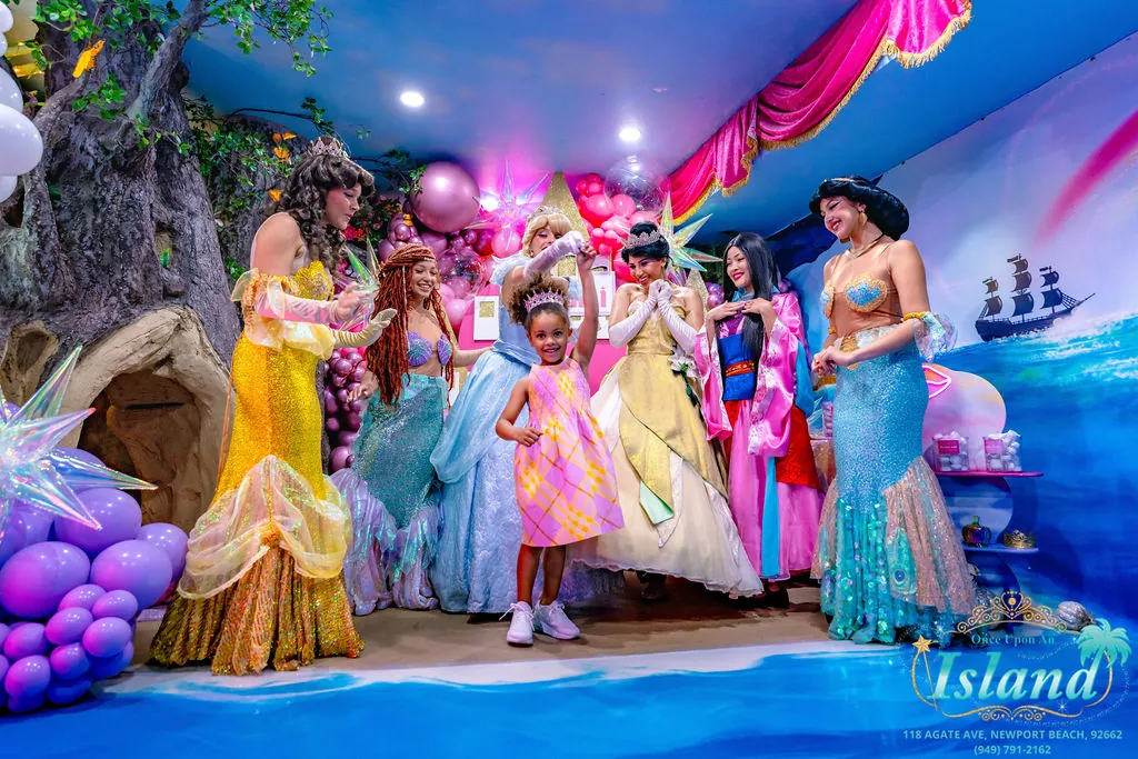 The birthday girl dancing with her full court of princesses
