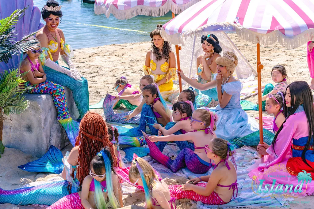 Princess storytime on the sand beneath striped umbrellas