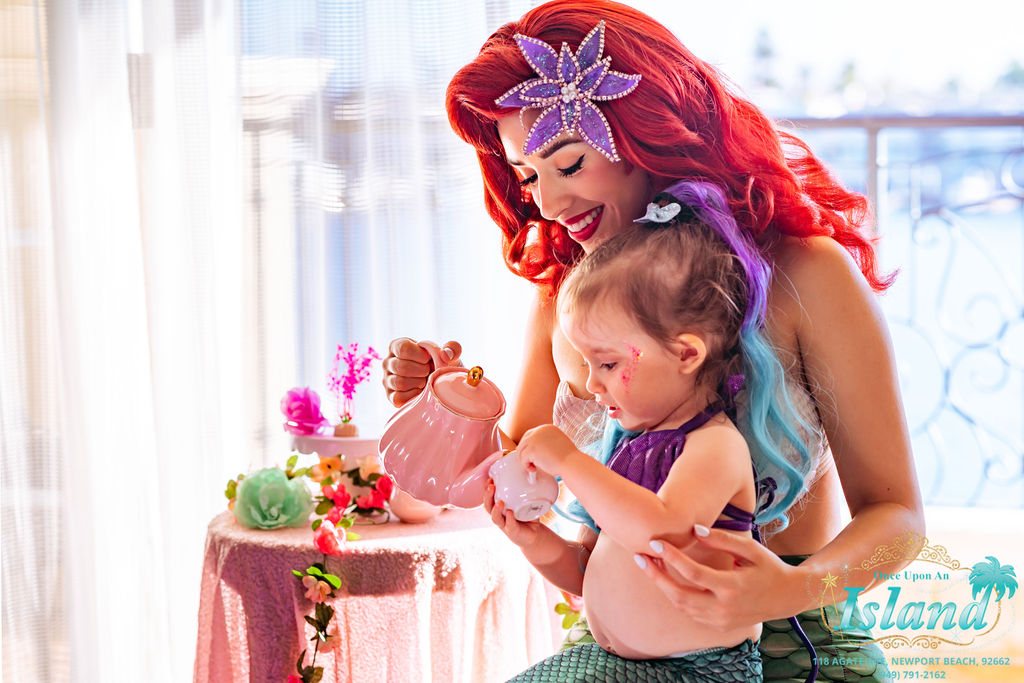 The Mermaid Princess hosting a tea table with two little guests at a hotel celebration