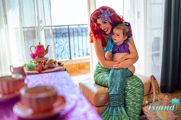 A child reaching out to the Mermaid Princess at the salon mirror