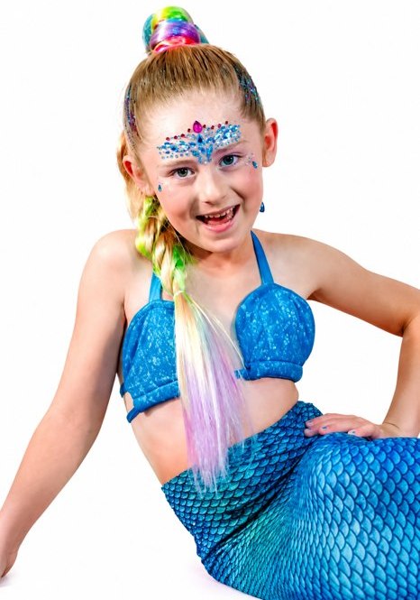 A VIP mermaid with deluxe hairstyle, statement face gems and glitter