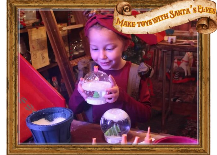 A child making a snow globe with Santa&rsquo;s elves at Once Upon a Christmas